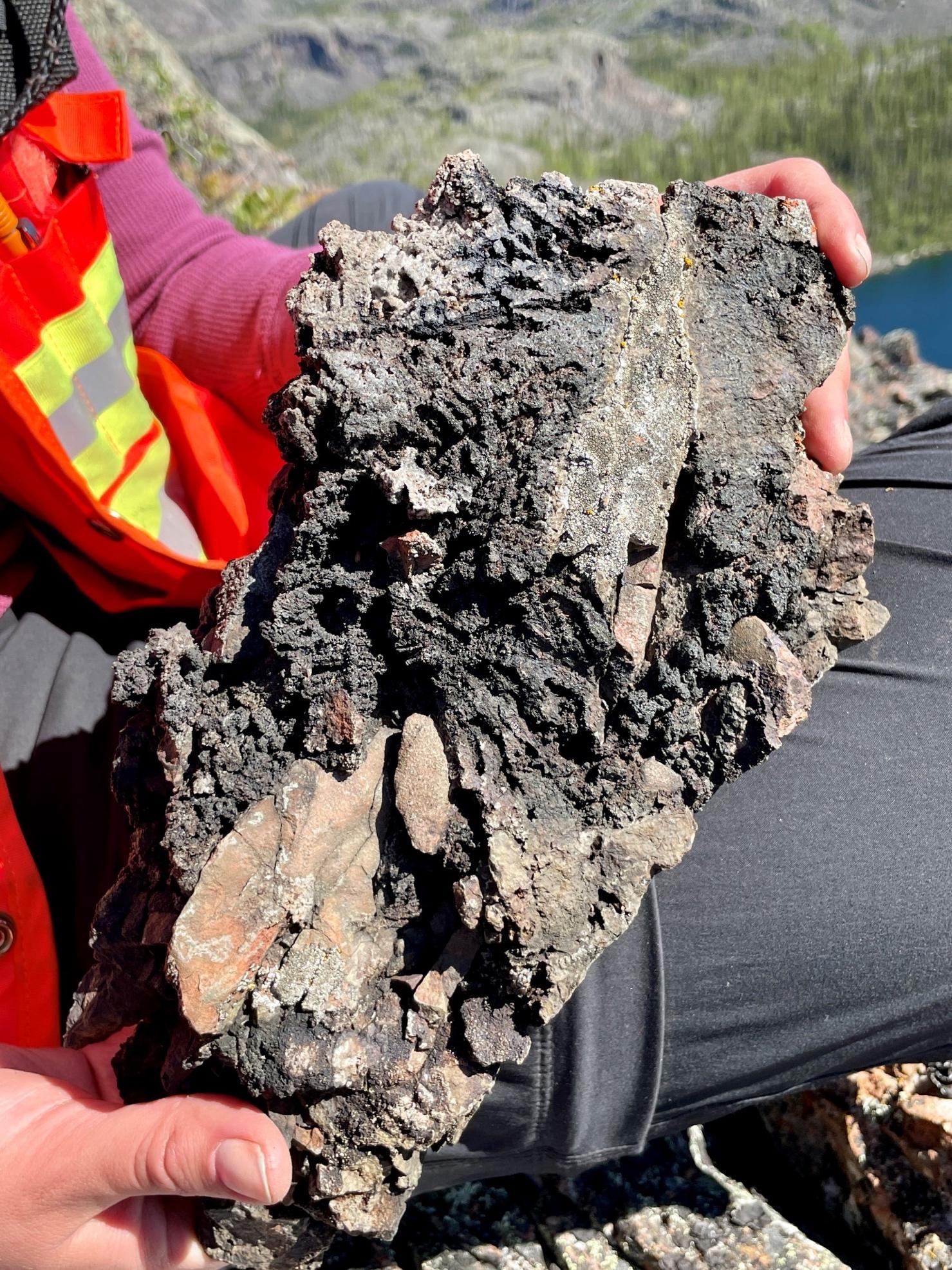 Photograph of sample F005909 which returned 5.35% Ag. Tarnished native silver and calcite cement can be observed between the clasts of potassic altered diorite.